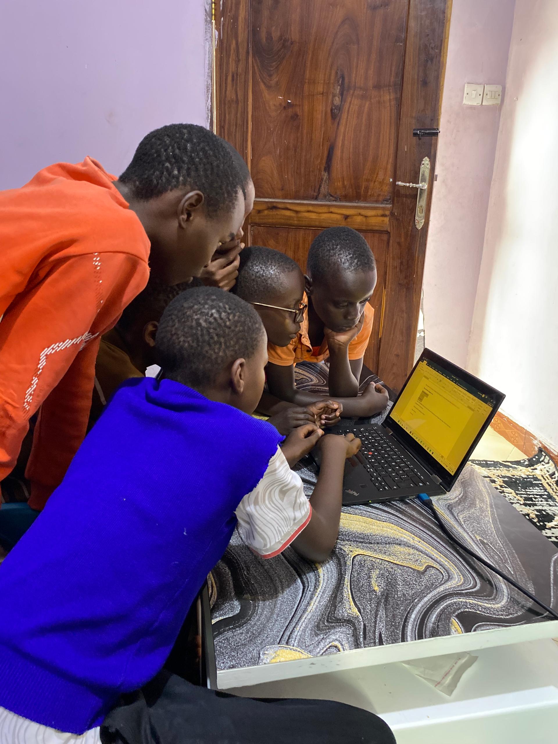 Young students learning computer skills together